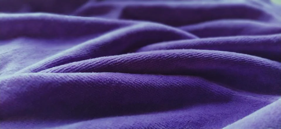 Blue wrinkled velvet. Blue-violet velvet fabric, beautifully laid in waves. S Stock Photos