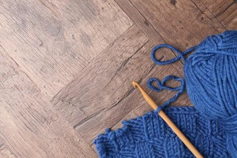 Blue yarns, pattern sample and crochet hook on wooden table, top view. Spac.. 写真素材