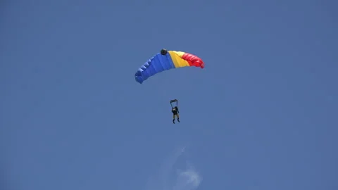 Blue, yellow and red colored paraglider in the clear blue sky 库存影片 318180185