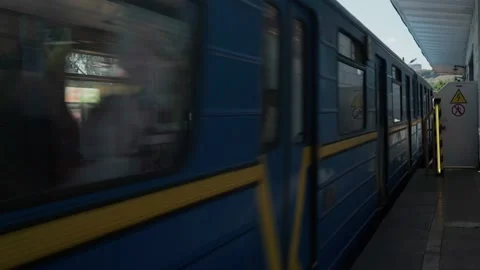 Blue Yellow Metro Train Passes Through Ground Station on Bridge Over Dnieper Video stock 159492084