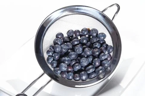 Blueberries into a colander Stock Photos
