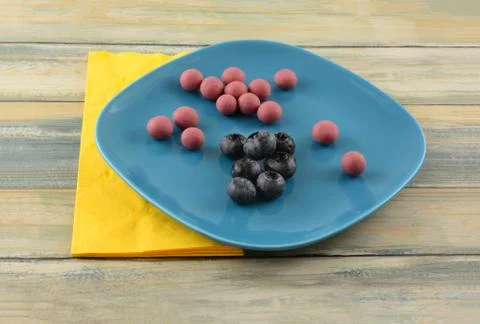 Blueberries dipped in ruby cacao chocolate with fresh blueberries Stock Photos