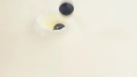 Blueberries falling into milk Stock Footage 85075118