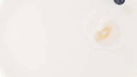 Blueberries falling into milk Stock Footage 85075271