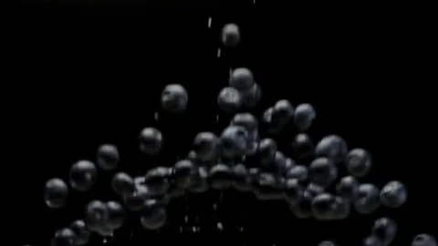 A Blueberries Falling in Slow Motion on a Black Background Stock Footage 148074335