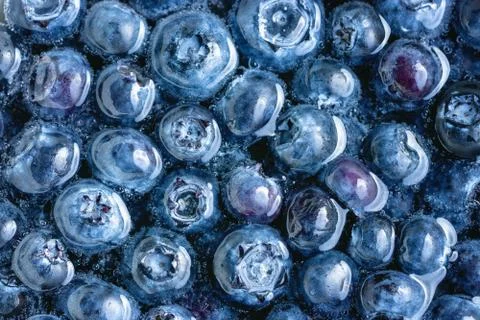 Blueberries floating in water with bubbles Stock Photos