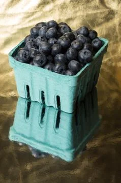 Blueberries on gold surface Stock Photos