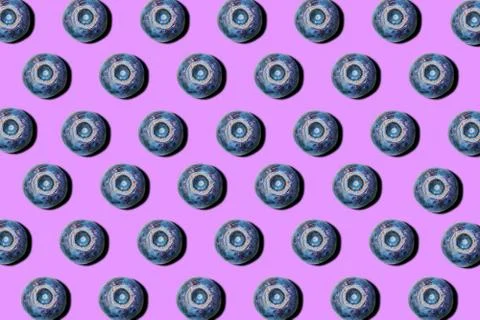 Blueberries on a purple background. Pattern. Stock Photos