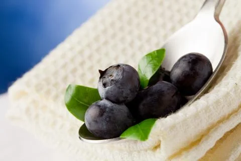 Blueberries on spoon Stock Photos