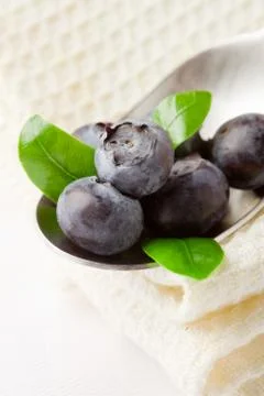 Blueberries on spoon Stock Photos