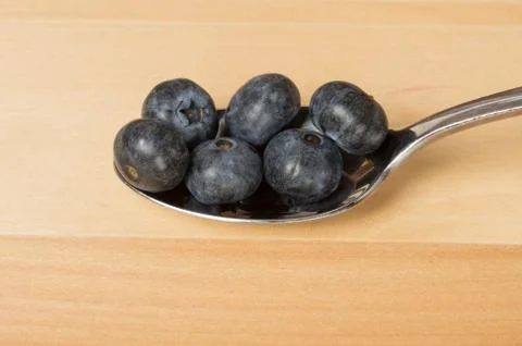 Blueberries on a spoon Stock Photos