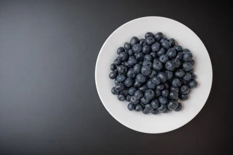 Blueberries on a whithe and black background Stock Photos