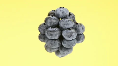 Blueberries on a yellow mirror. Side view. Loop motion. Rotation 360. Stock Footage 168587298