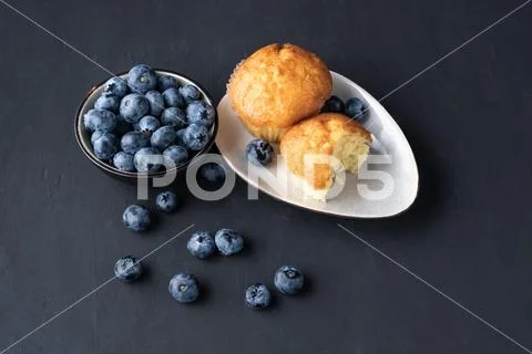 Blueberry antioxidant organic superfood in ceramic bowl and sweet muffin Conc Stock Photos