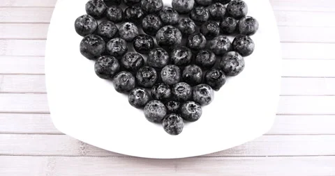 Blueberry berry heart-shaped composition on white background Stock Footage 143670194