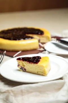 Blueberry Cheesecake slice include caramel with fork and knife served in pl.. Stock Photos