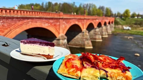 Blueberry Cheesecake Slice Served Outdoors Near Historic Red Brick Bridge River Stock Footage 336780474