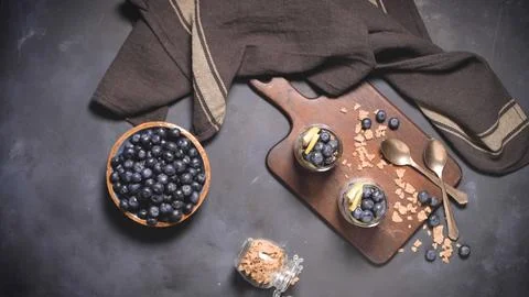Blueberry Chia Seed Pudding Flat Lay with Fresh Berries and Granola Stock Photos