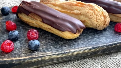 Blueberry eclairs on a dark blue background Video stock 172045084