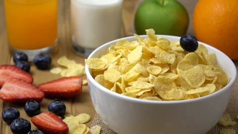 Blueberry falling in to corn flakes splashing in slow motion. Stock Footage 94503812