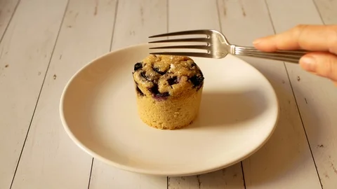 Blueberry filled muffin split open with fork Stock Footage 95641245