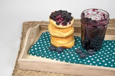 Blueberry jam on bread roll Stock Photos