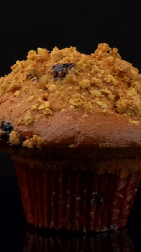Blueberry Muffin Rotating on Dark Background Under Studio Lighting Stock Footage 330517437