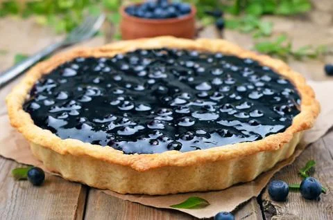 Blueberry pie on rustic table Stock Photos