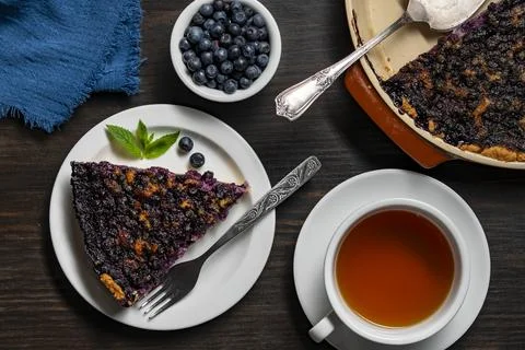 Blueberry pie slice with tea cup, top view, closeup Stock-Fotos