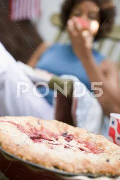 Blueberry pie on table, woman in deckchair (4th of July, USA) Stock Photos