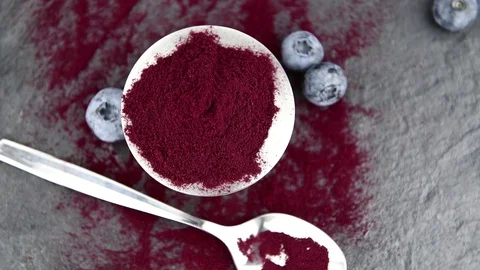 Blueberry powder on a rotating plate (4K; seamless loopable) Stock Footage