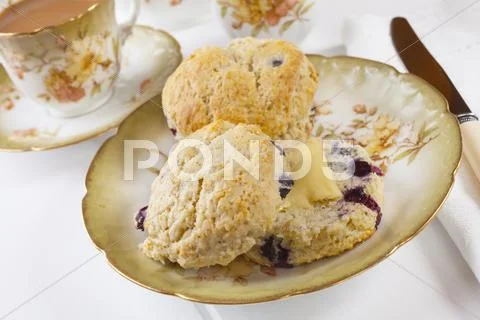 Blueberry scones with butter and a cup of tea Stock Photos