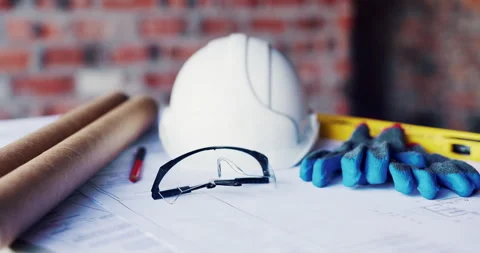 Blueprint, architecture and helmet on construction site for building safety, PPE Stock Footage 336779201
