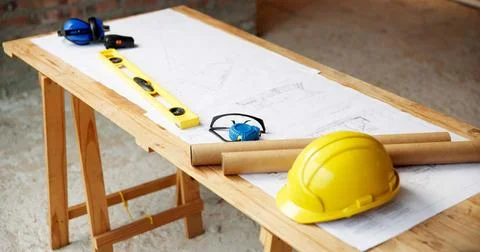 Blueprint, architecture and tools on construction site for safety, PPE or Stock Photos