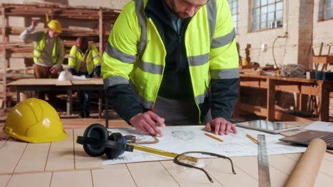 Blueprint, architecture and writing with man in workshop for site plan scale, Stock Footage 338046447