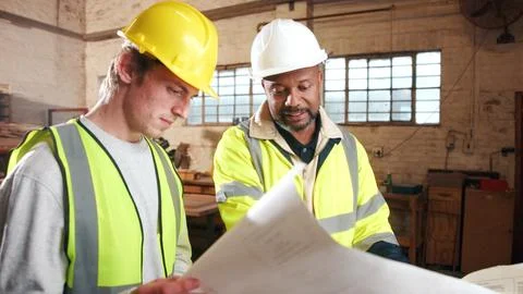 Blueprint, engineer and team at construction site for development, planning.. Foto stock