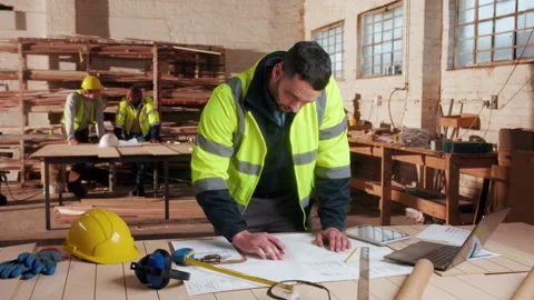 Blueprint, engineer and writing with man in workshop for site plan scale, review Stock Footage 338048078