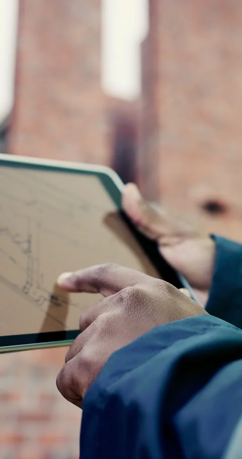 Blueprint, hands and tablet screen with man on construction site for development Stock Footage 336795776