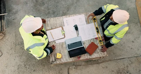 Blueprint, laptop and construction workers with handshake on site for industrial Stock Footage 336224795