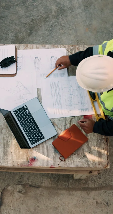 Blueprint, man and construction worker with laptop on site for planning home Stock Footage 336243431