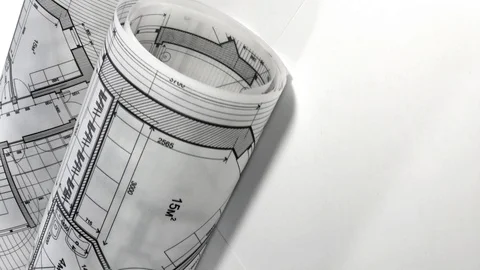 Blueprints - architectural drawings rolls smoothly rotate on the white surface Stock Footage 96341653