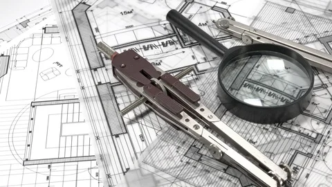 Blueprints - rolls of architectural drawings, loupe - magnifying glass &amp; compass Stock Footage 93901853