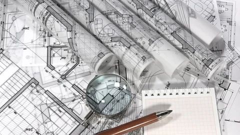 Blueprints - rolls of architectural drawings, notebook, loupe - magnifying glass Stock Footage 94803530