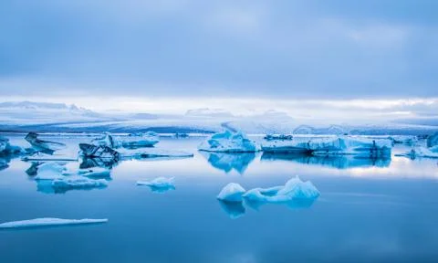 Bluest, blues of an Icelandic iceberg lagoon under the midnight sun Stock Photos