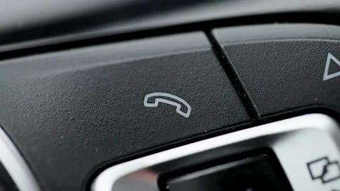 Bluetooth buttons located on the steering wheel of a car to talk over the phone Stock Footage 194714884