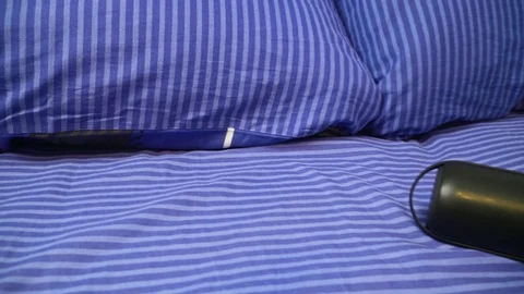 Bluetooth speaker plays music in the bed Stock Footage 103234759