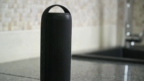 Bluetooth speaker plays music in a kitchen Stock Footage 103234663
