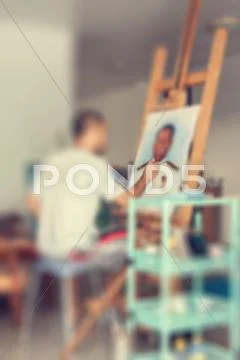 Blur of artist painting a man portrait Stock Photos