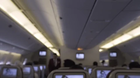 Blur background of airplane interior and passengers sitting seat Stock Footage 107091588