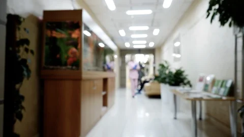 Blur background of clinic corridor with walking woman doctor in pink uniform. Stock Footage 113079499